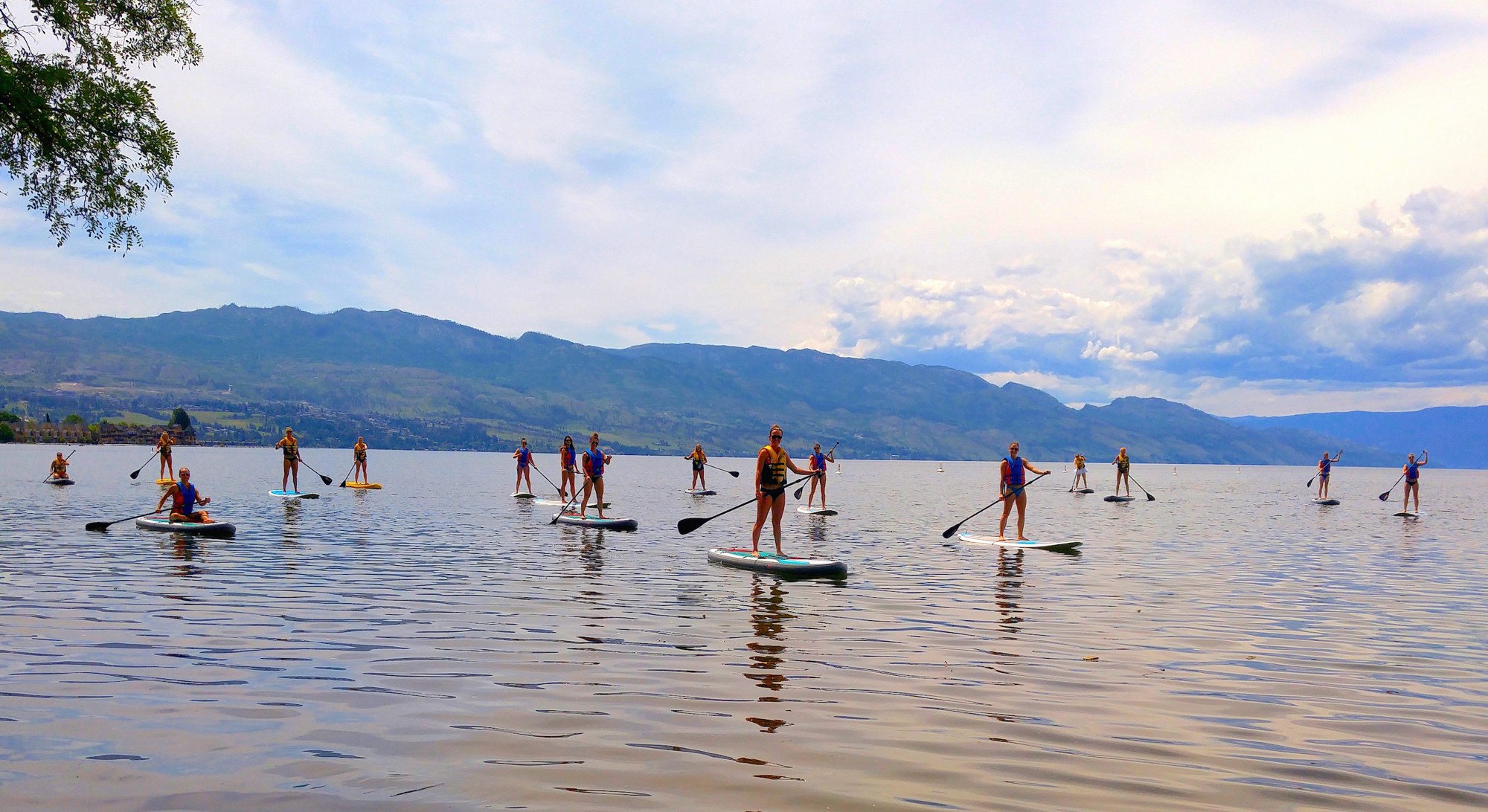 A group paddleboarding together on Okanagan Lake